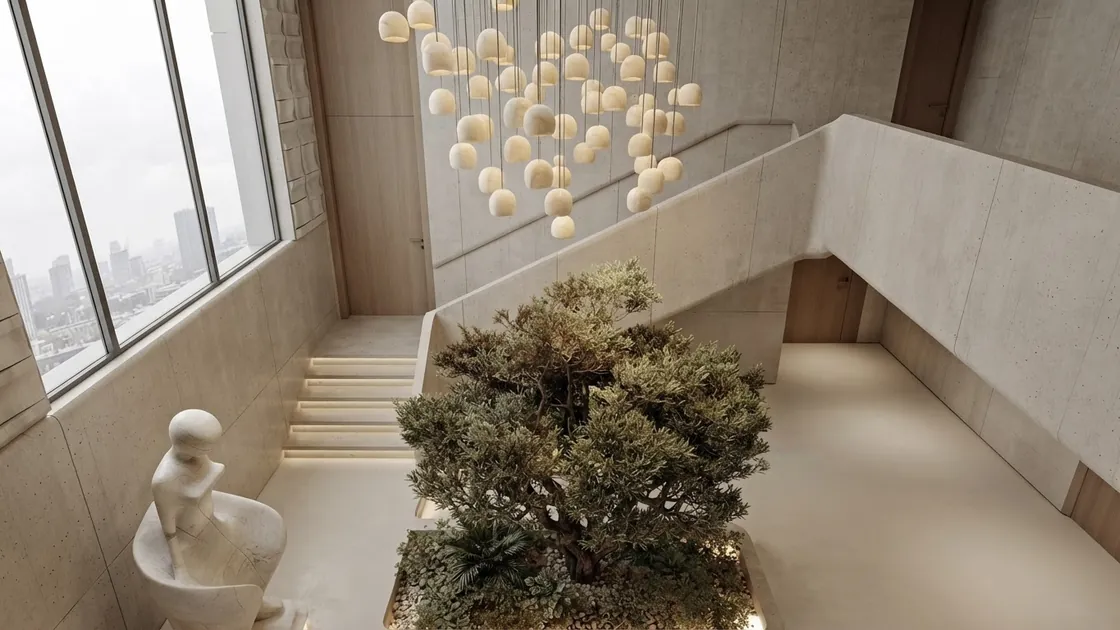Light stone staircase wrapping around a courtyard tree with pendant lights