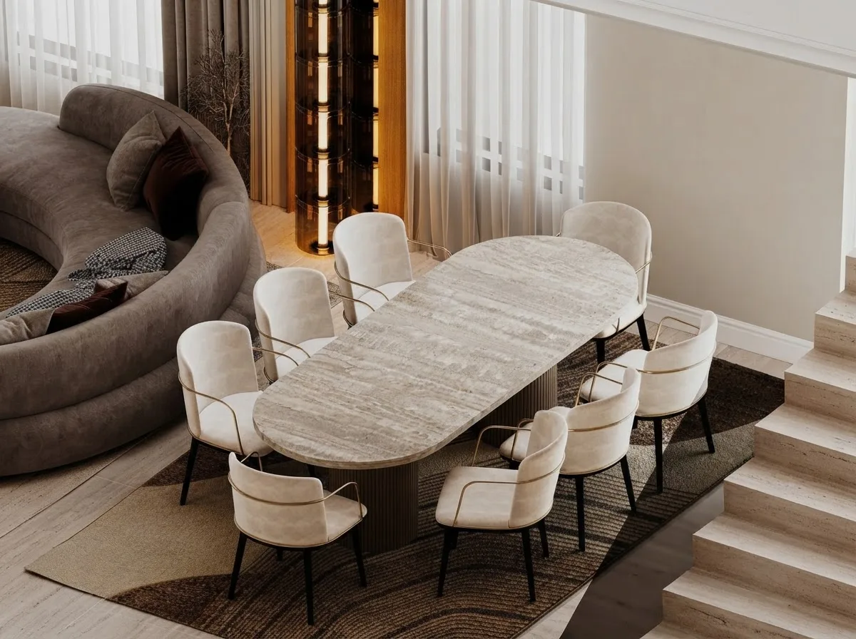 Dining room with an oval travertine table, cream chairs and a curved sofa behind, walls in Agreeable Gray