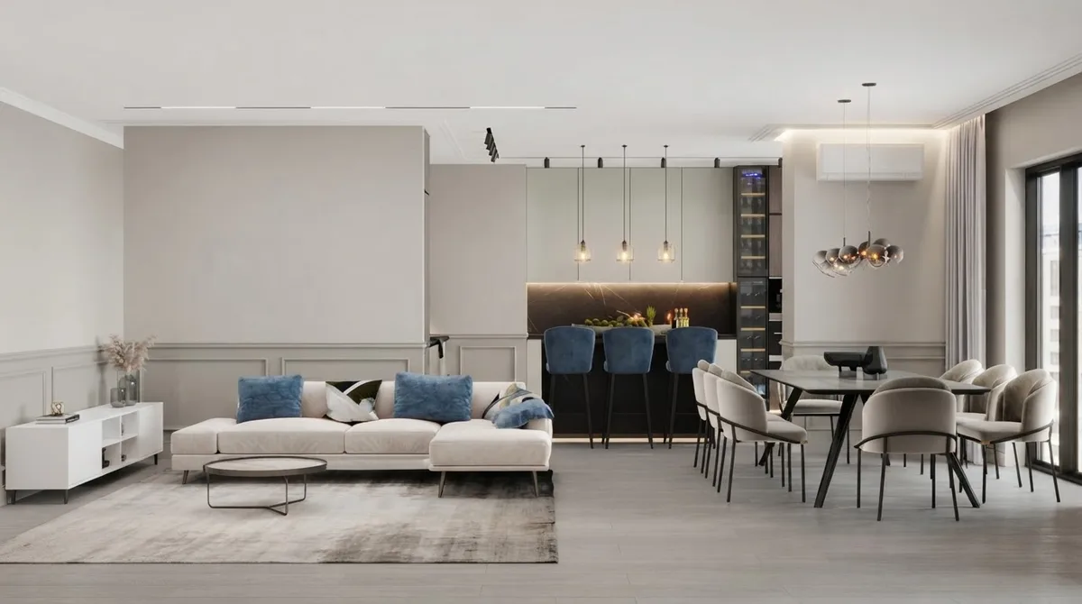 Open kitchen and living room with white cabinets, a dark island with navy bar stools and a sectional beyond, walls in Agreeable Gray