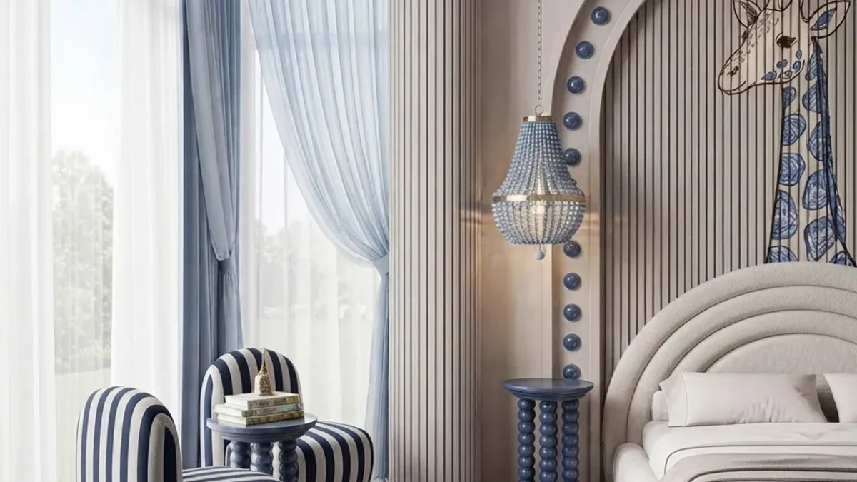 Girls bedroom design in dusty blue and cream: an arched fluted headboard wall, striped armchair, pendant light and soft canopy curtains