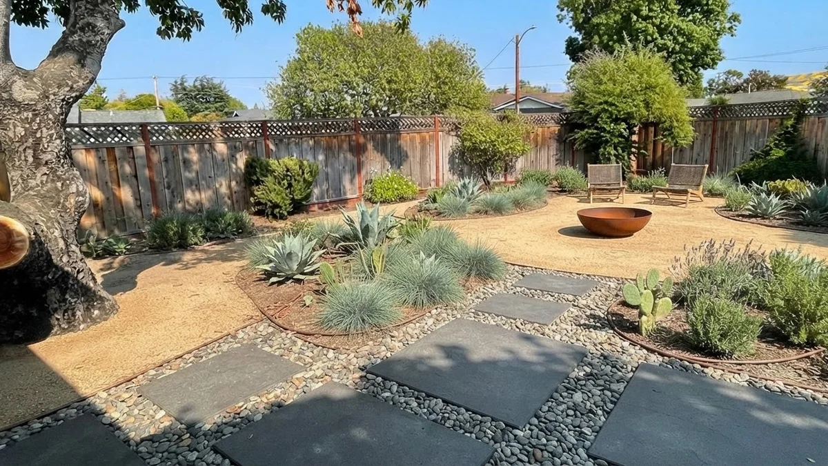 The base backyard rendered as a modern xeriscape with decomposed granite, concrete pavers, blue grama grass, agave and a steel fire bowl