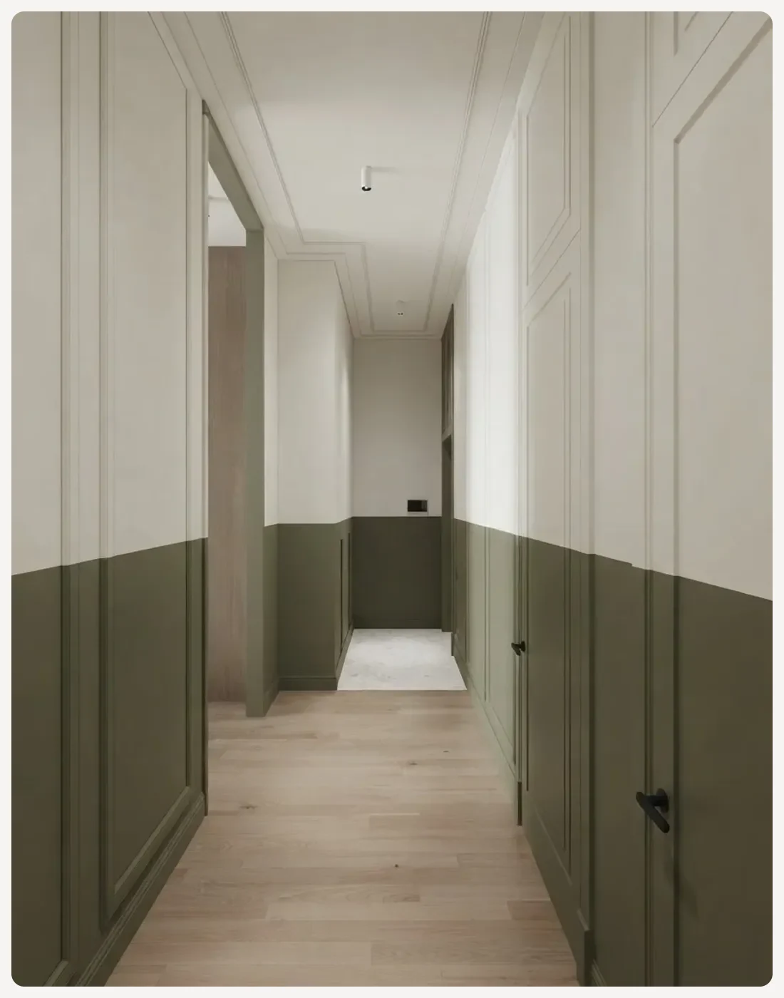 Hallway with the lower third of the walls painted deep olive green and a clean horizontal line separating it from the off-white above