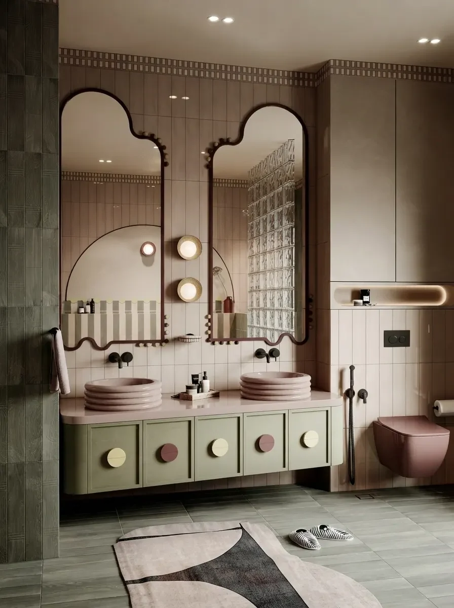 A retro bathroom with sage green cabinetry, pink tile and arched double mirrors