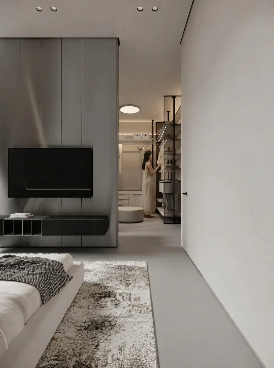 Minimal master bedroom render with a low bed facing a wall-mounted TV, and a walk-in closet visible behind a smoked glass partition at the far end
