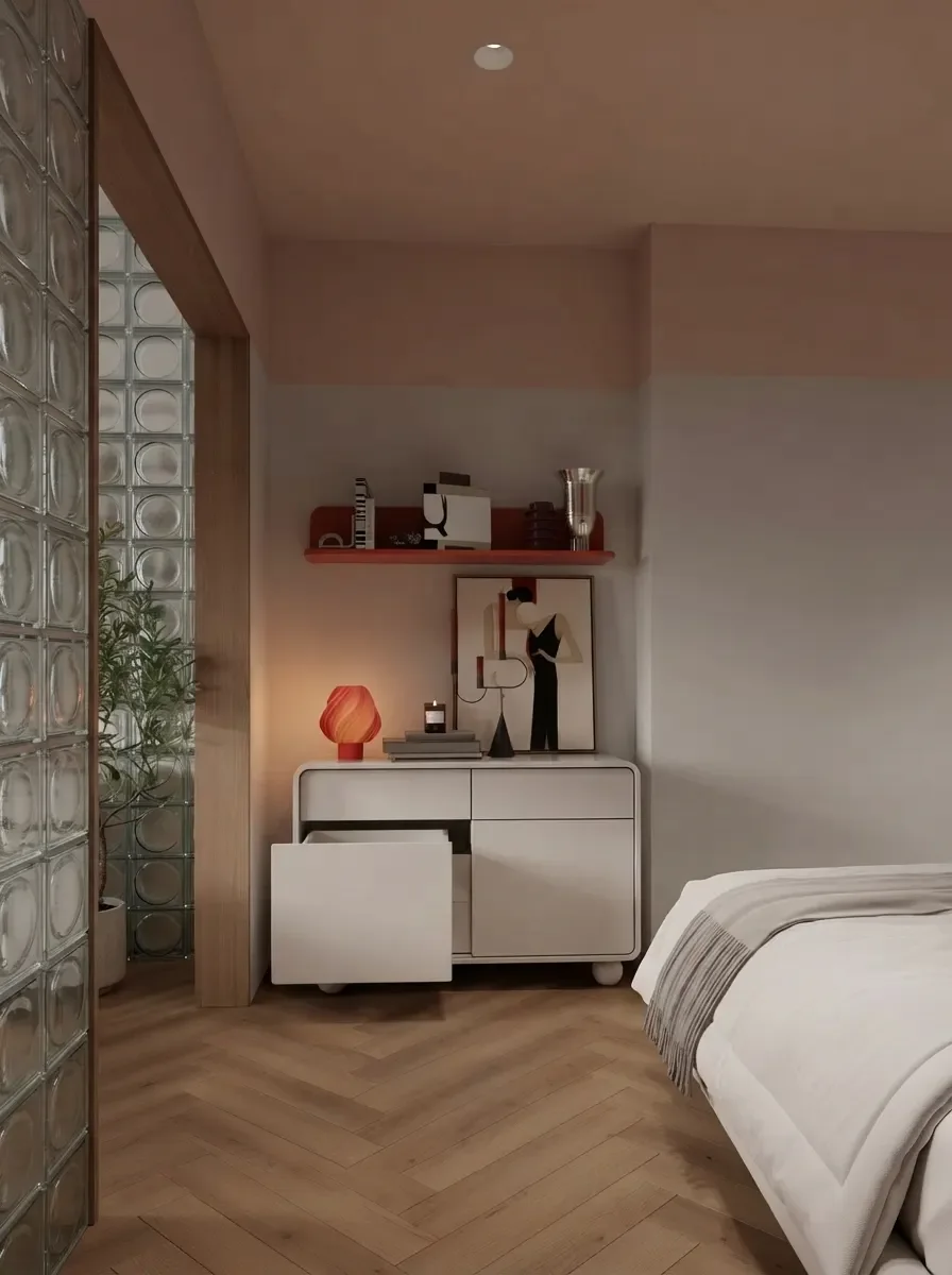 Compact white walk-in wardrobe render with open shelving, hanging rails and drawers behind a glass block wall, in the same small apartment bedroom