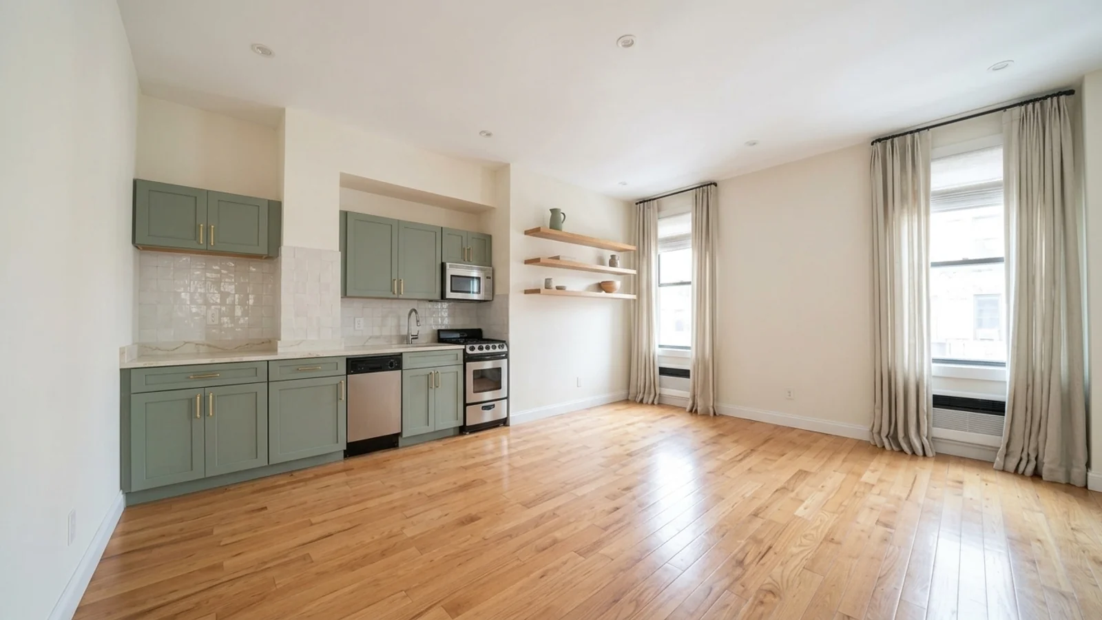 After renovation AI preview of the same kitchen: sage green shaker cabinets with brass handles, quartz countertop, white zellige backsplash, oak floating shelves, warm off-white walls