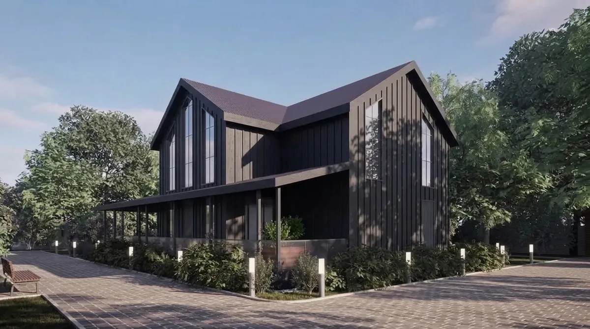 The same house re-clad in black board and batten siding with battens about 16 inches apart, keeping the gable windows, porch and landscaping