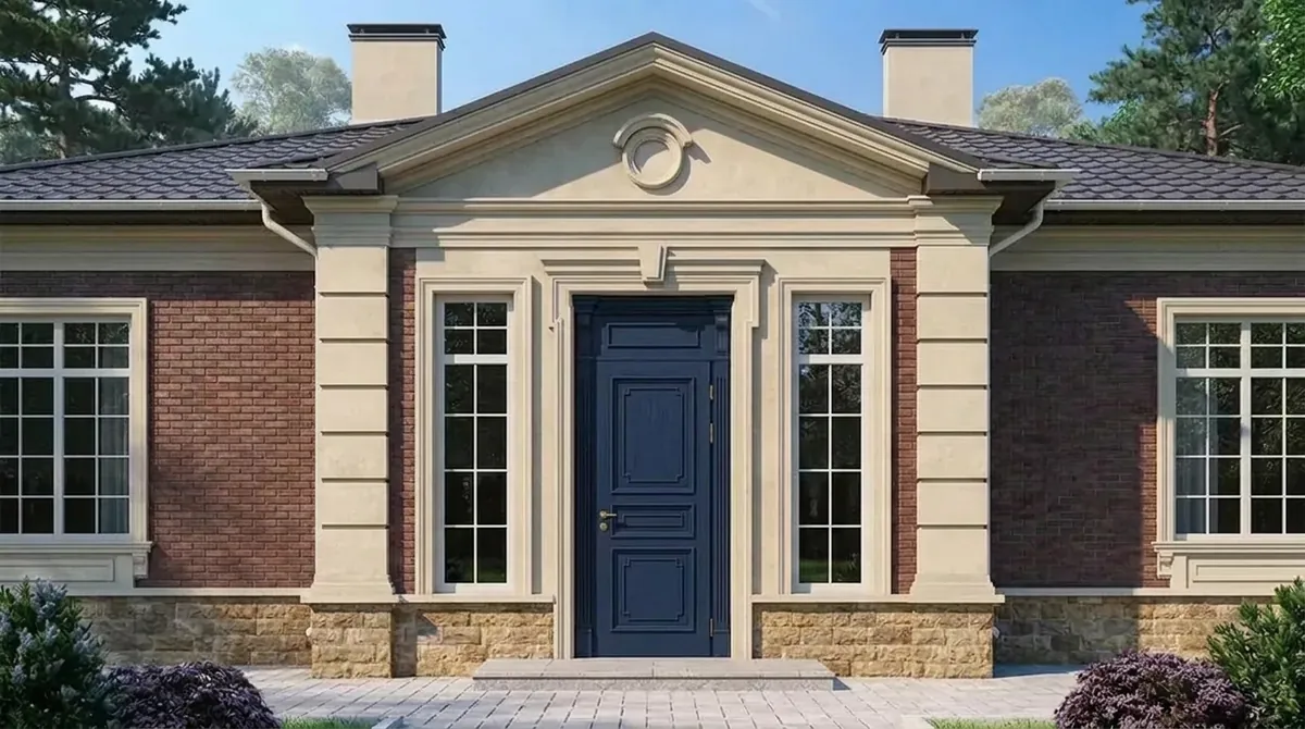 Red brick house with a cream stone pediment entry and tall sidelight windows, the front door painted navy blue