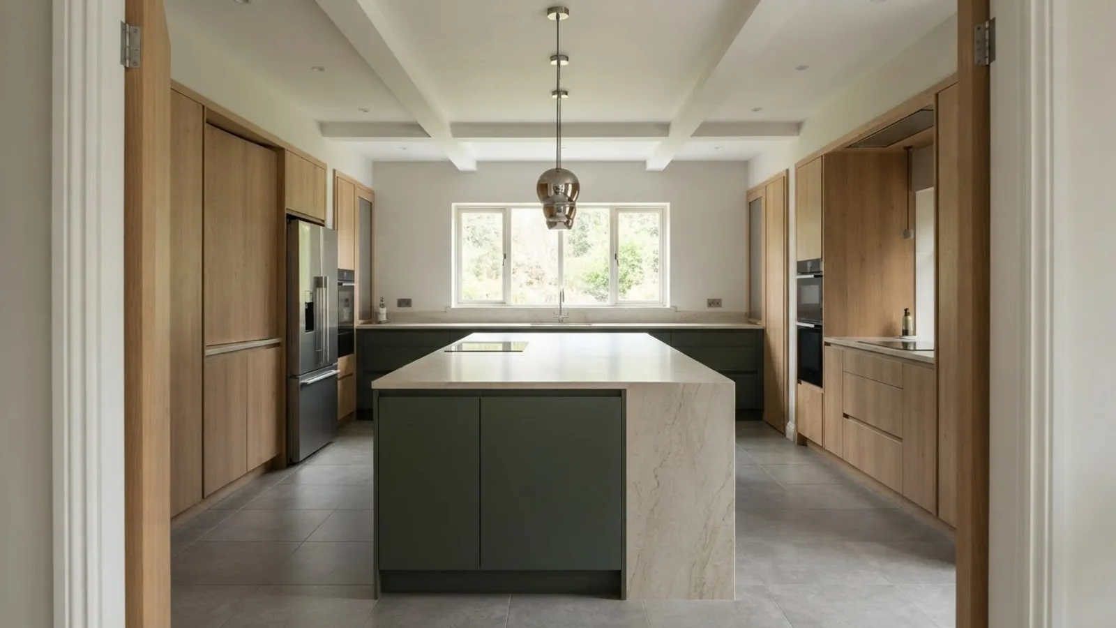 A kitchen with an island shot from the doorway, the standard starting frame for a 360 orbit camera move in a listing video