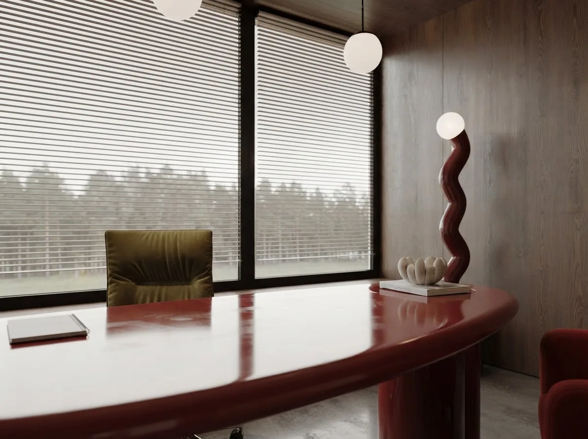 Venetian blinds filling a corner window above a desk, the slats tilted to diffuse the daylight