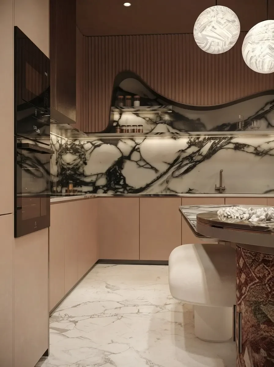 A blush pink kitchen with a dramatic veined marble backsplash and brass fittings