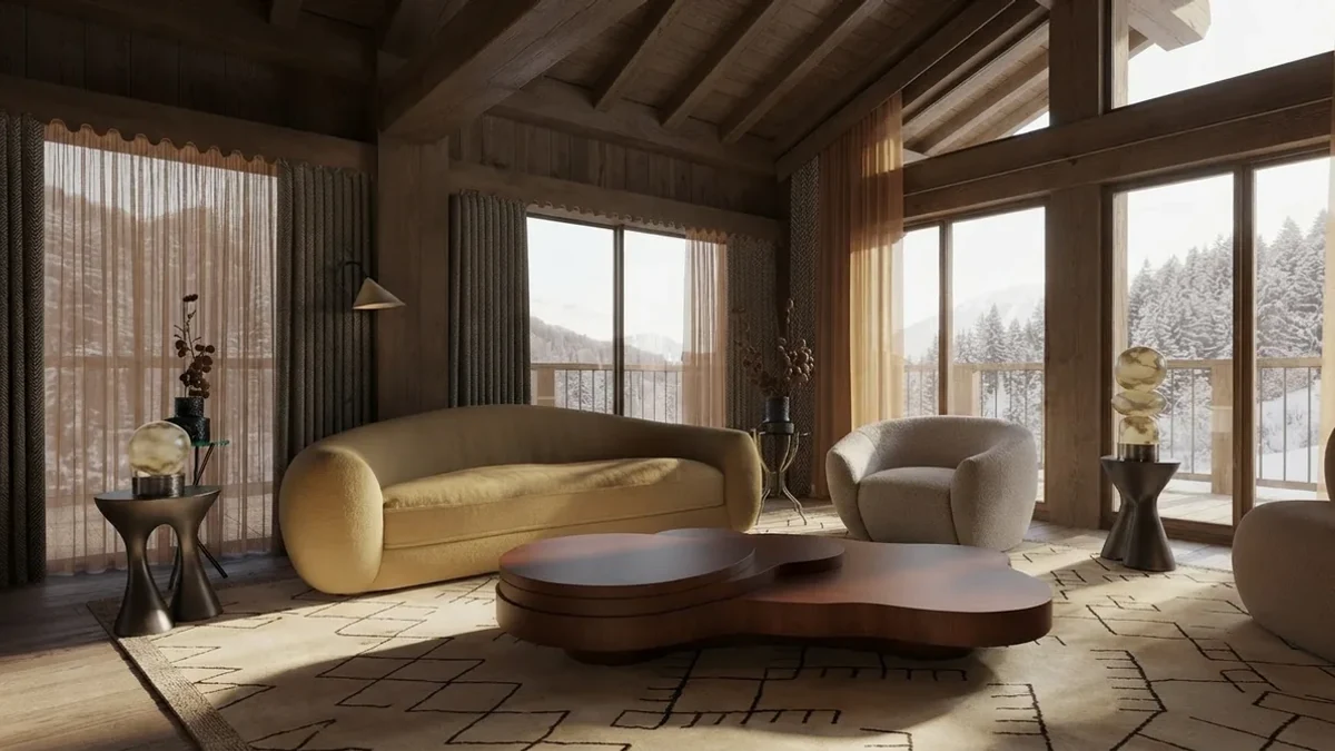 Warm chalet living room makeover result: a curved butter yellow sofa and cream lounge chairs around a low organic wood table, mountain light through full-height windows