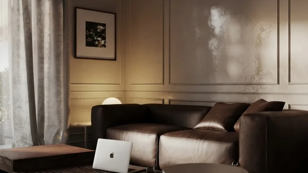 Moody living room makeover result: a deep brown leather sofa in warm low evening light against panelled walls