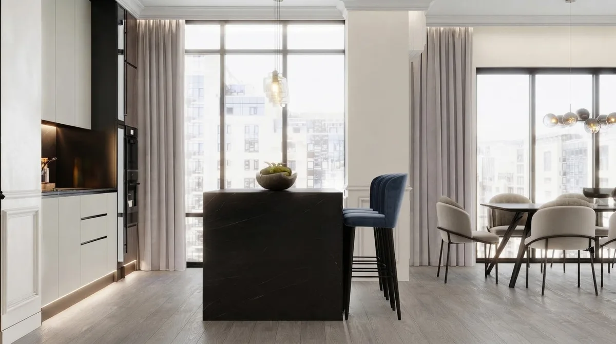 Kitchen with a dark stone island, navy velvet bar stools and pendant lights, walls in Alabaster