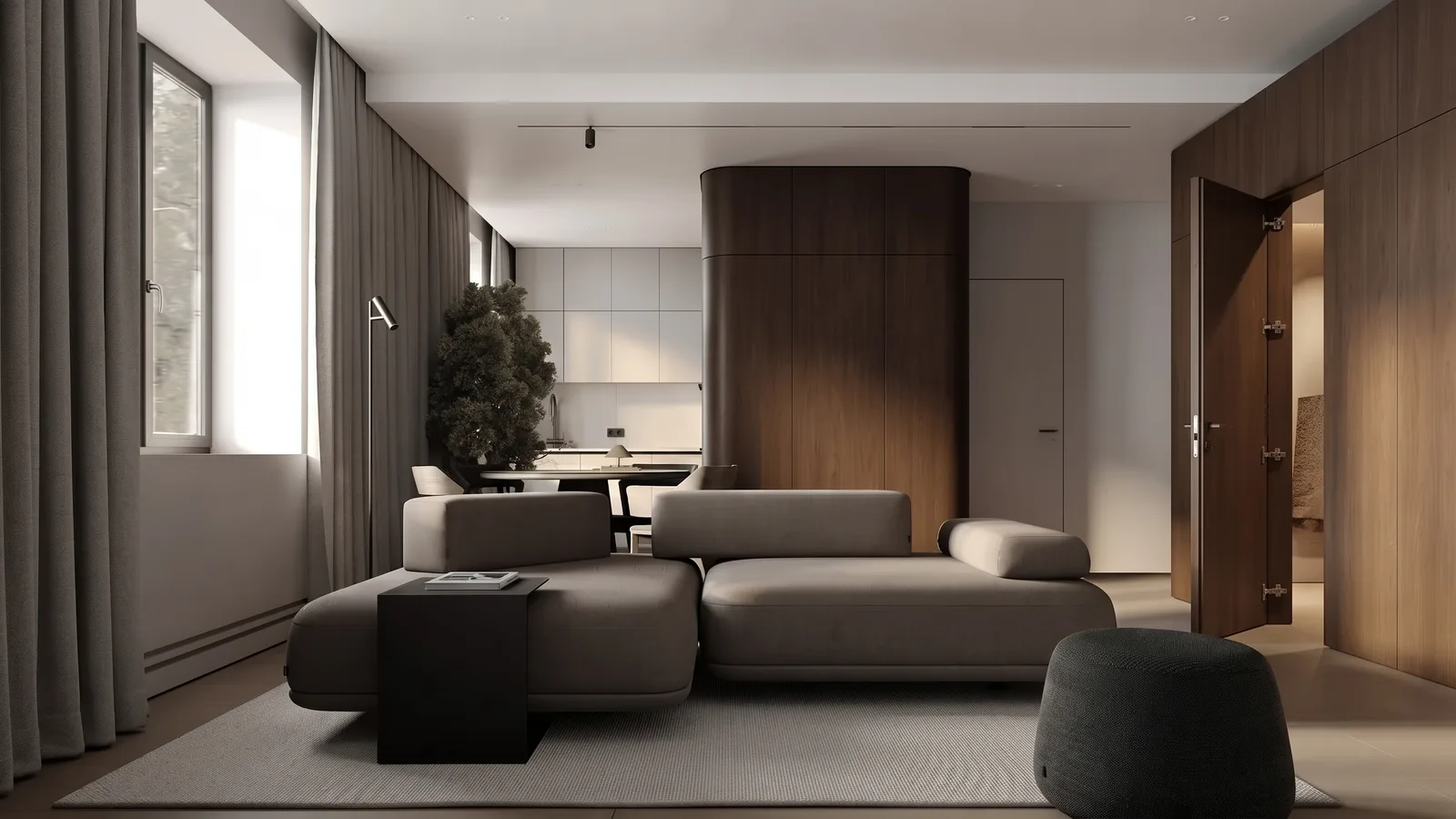 A charcoal low modular sofa with bolster arms in a minimalist apartment with wood panelled walls, a door in the panelling on the right standing open to a softly lit hallway