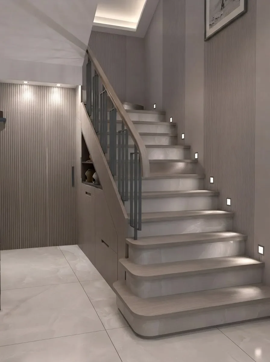 A marble tread staircase with pull-out shoe drawers built into the steps and LED step lights