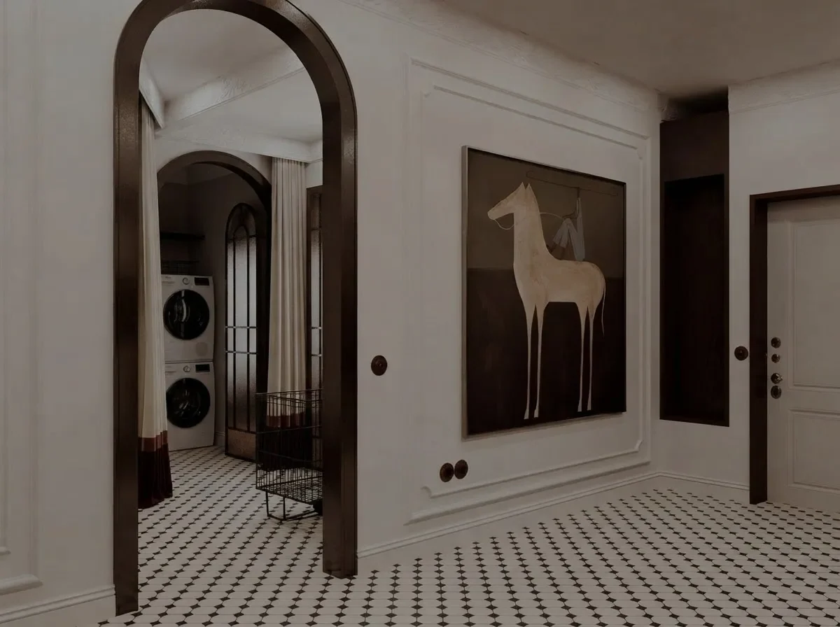 A white panelled hallway with a dark timber arched cased opening leading through to a laundry area, a large horse artwork and a patterned tile floor