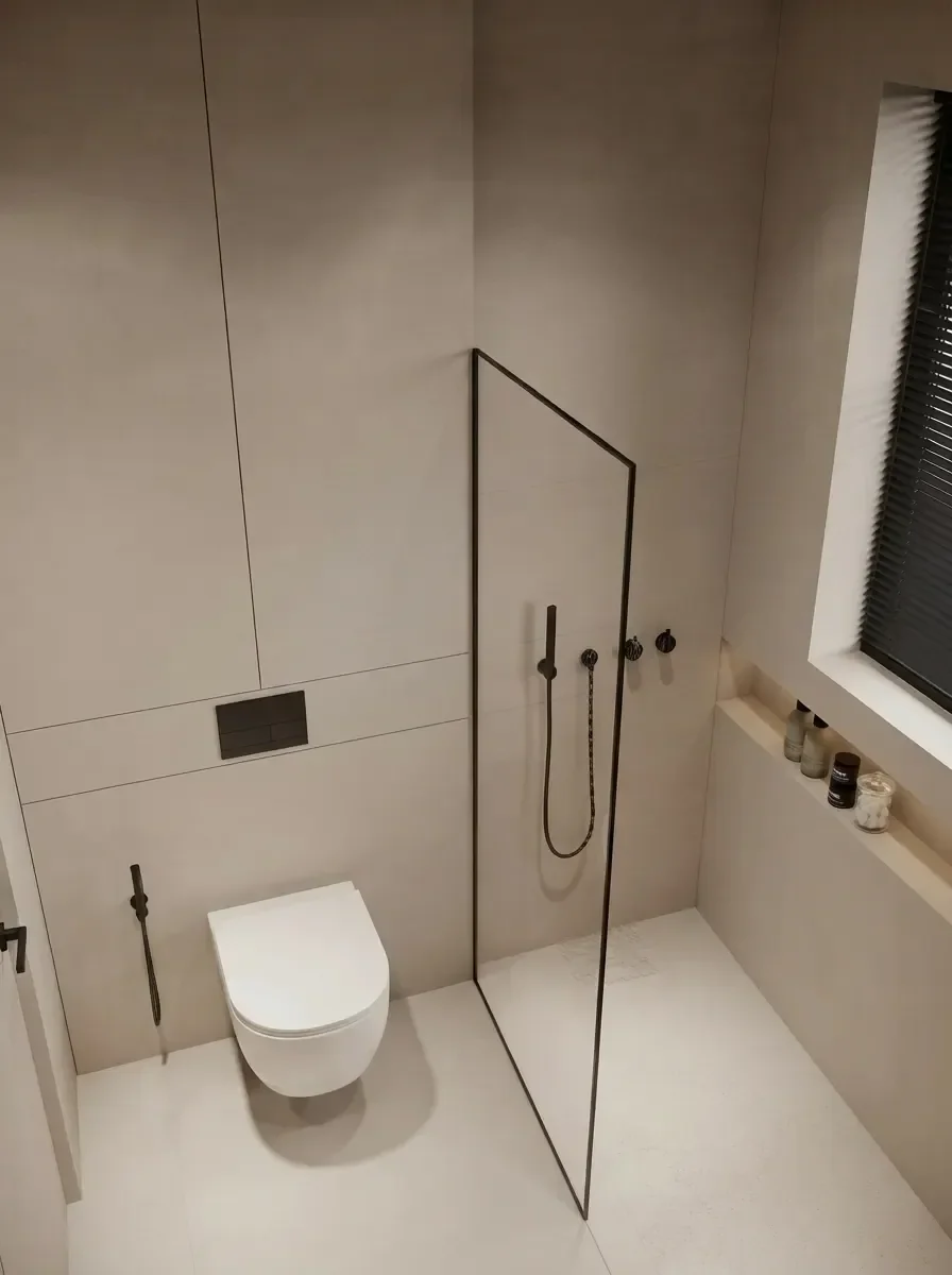 Walk-in shower behind a single fixed frameless glass panel with black fittings and continuous tile from floor to wall, rendered by MeltFlex