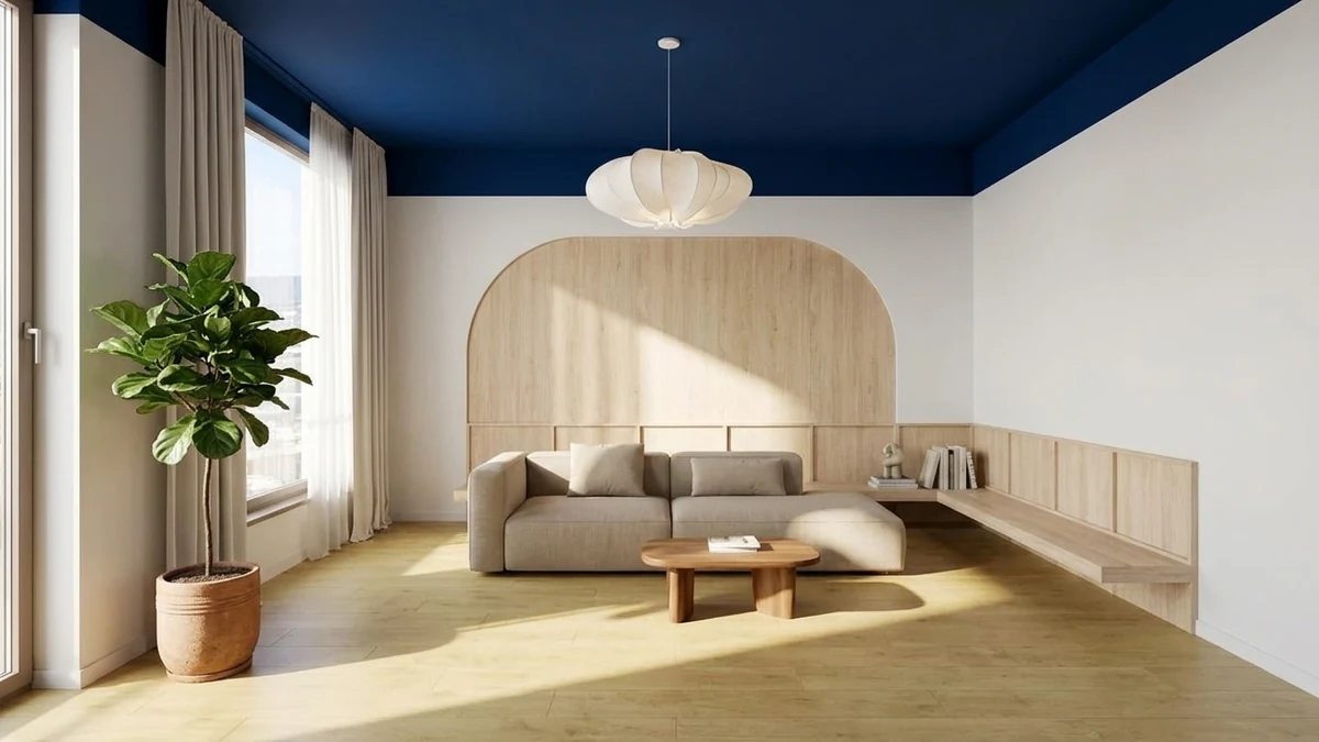 Living room with a bold painted statement ceiling in deep blue, white walls, warm wood floor, neutral sofa, and a sculptural pendant light, showing how a painted fifth wall transforms a plain room