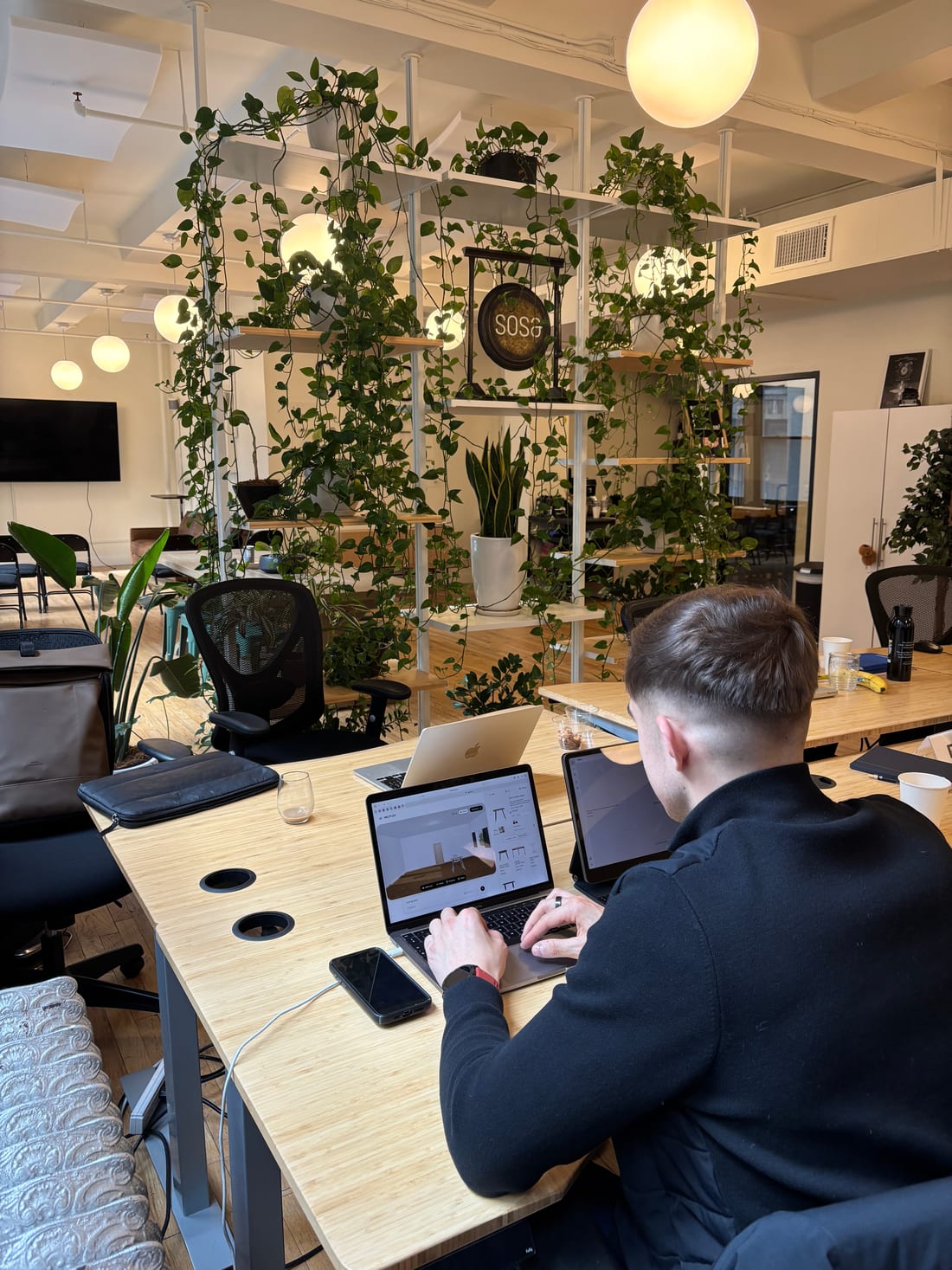 MeltFlex co-founder running an AI interior design render on a laptop in a New York office