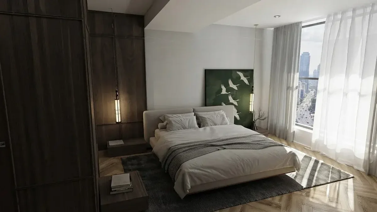 Dark timber bedroom with a low upholstered bed, a pendant reading light and one green painting of white cranes hung close above the headboard, city view through sheer curtains