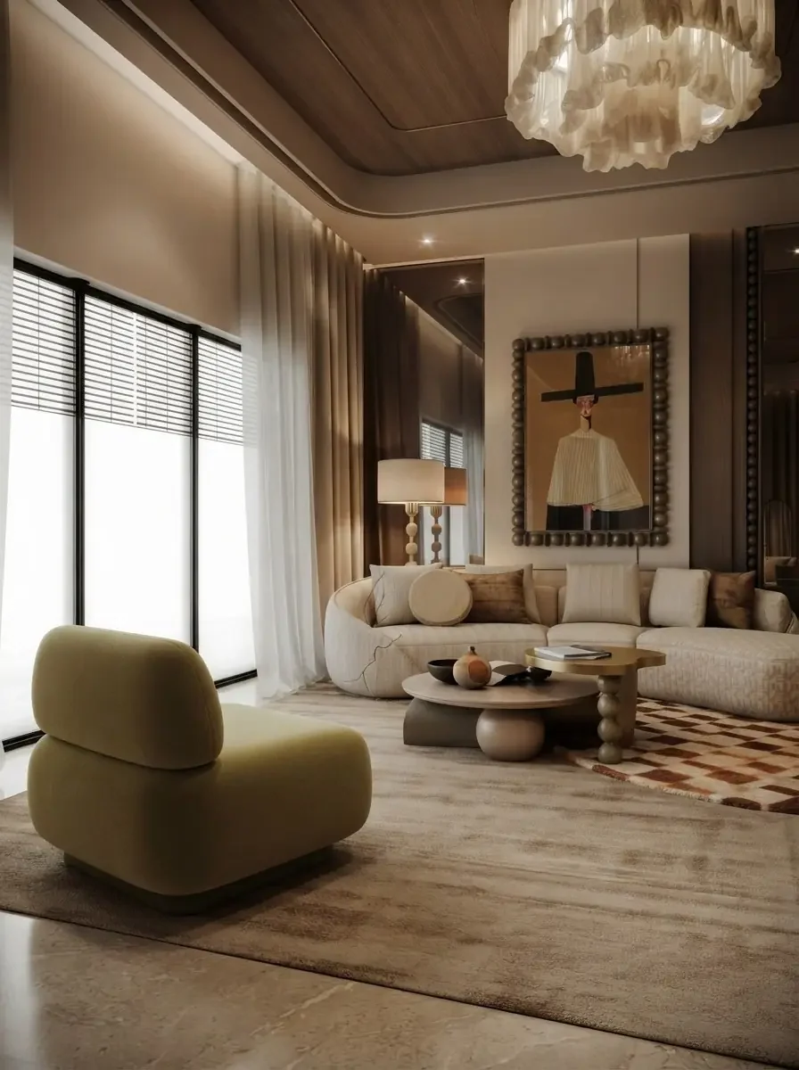 Neutral living room with a curved cream sofa, sculptural stone coffee tables and a geometric patterned rug visible under the seating group
