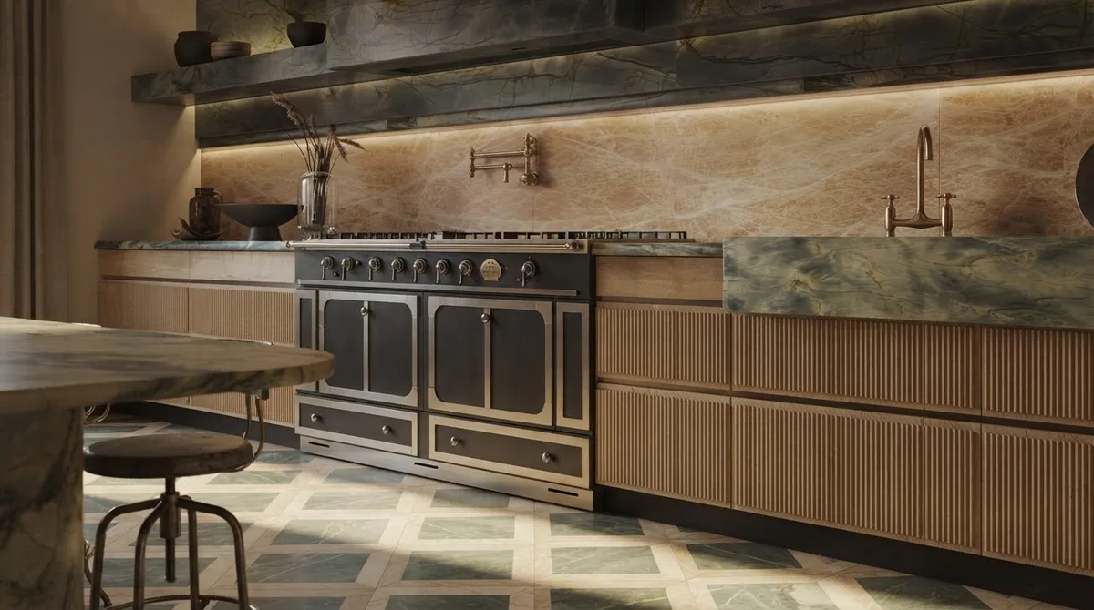 Chalet kitchen with a black and brass range cooker, green marble backsplash and counter, fluted pale timber cabinetry and a green and cream diamond patterned stone floor