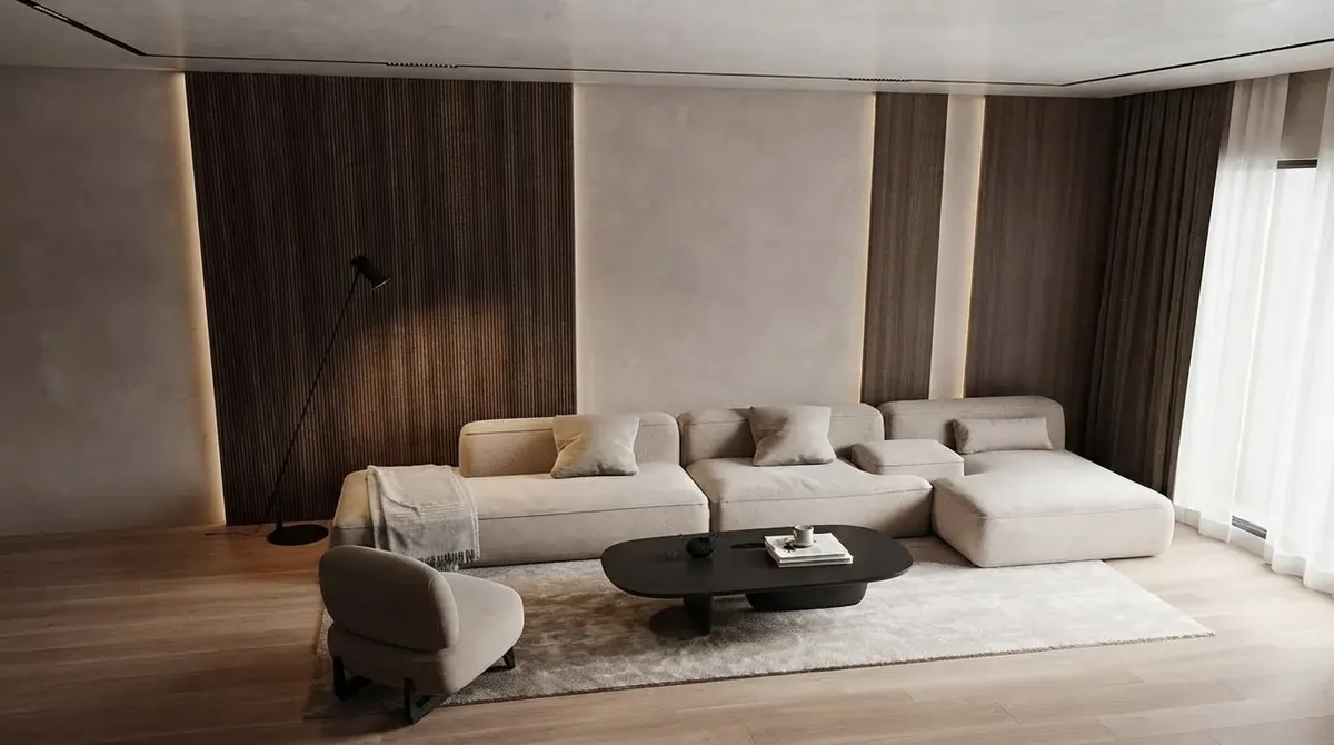 Minimal living room with smooth warm gray plaster walls between vertical dark wood panels, a cream sectional sofa, a black oval coffee table and a floor lamp