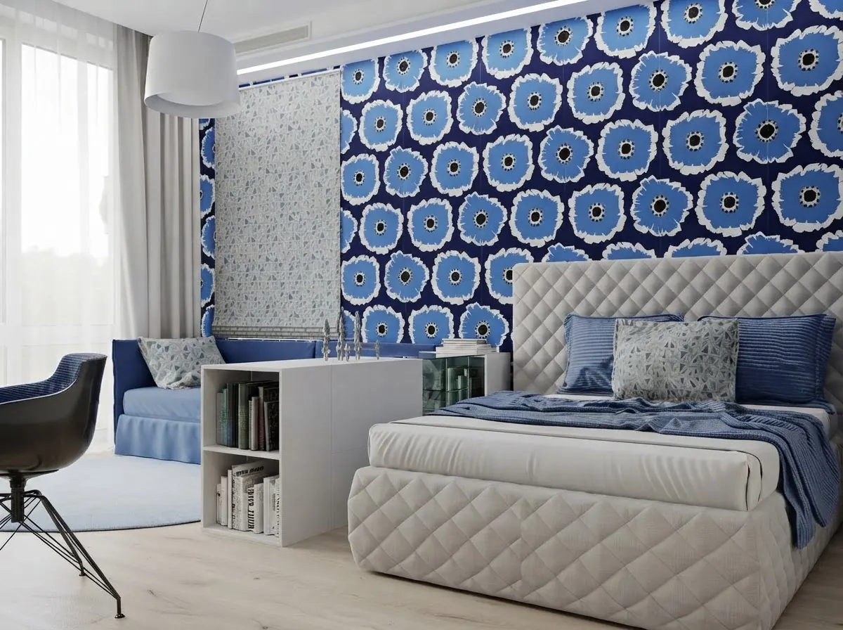 Teen bedroom with a bold navy and blue floral medallion wallpaper on the bed wall and a narrower panel of a different small print paper beside the window