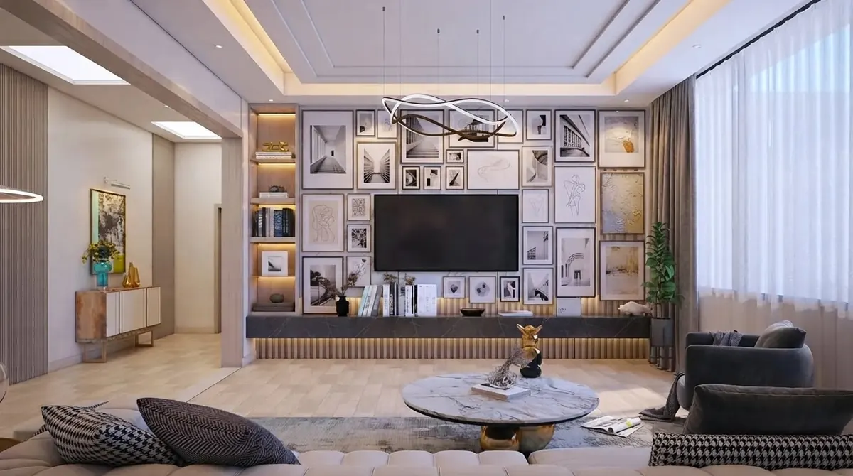 Classic lounge with a floor-to-ceiling gallery wall of framed prints around a wall-mounted television, a tufted sectional sofa and a round marble coffee table