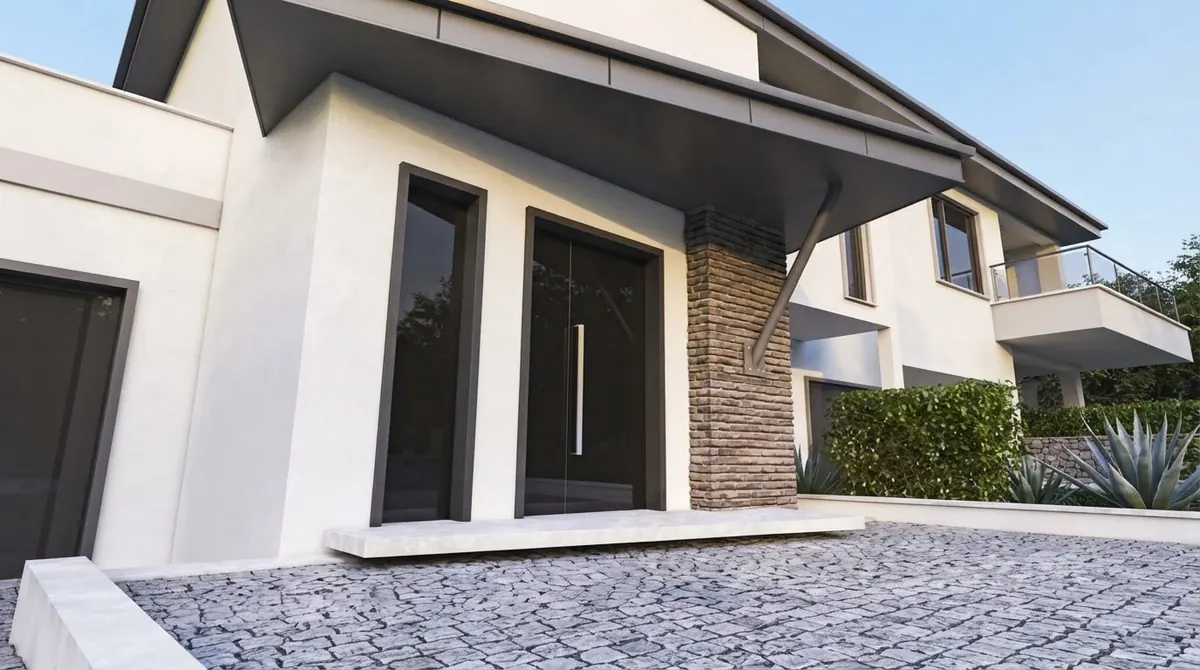 Modern white villa entrance with tall black double doors, a long steel pull handle, a stacked stone pier and a cantilevered canopy