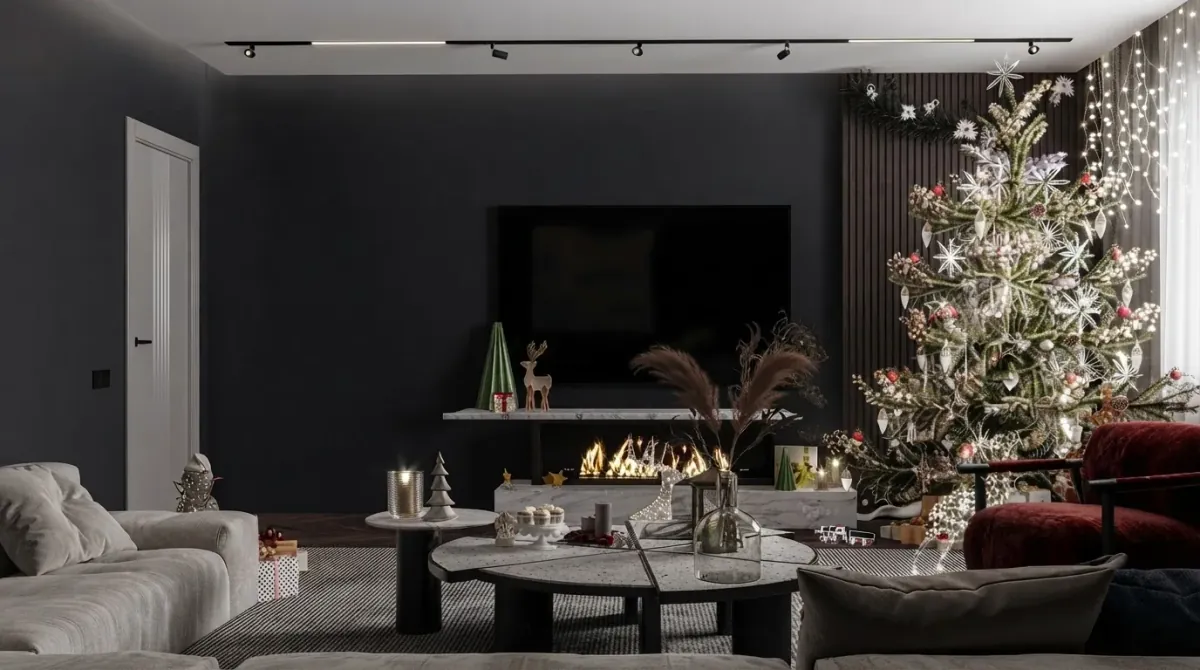 Dark living room with a wall mounted TV above a low console with a linear fire, a decorated Christmas tree in the far right corner of the same wall by the window, a grey sectional sofa and a burgundy armchair