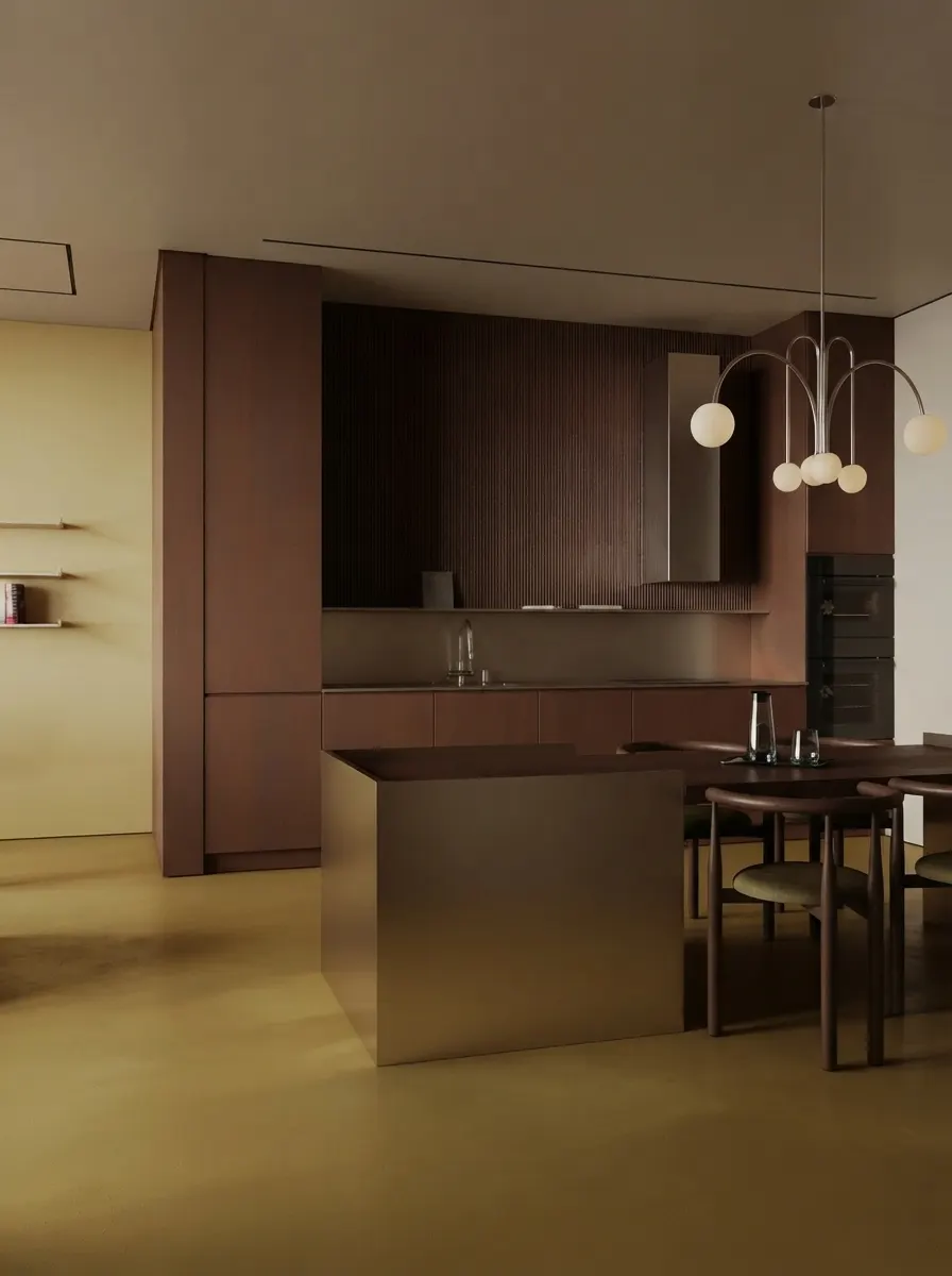 Open kitchen in dark timber with a bronze island, a sculptural multi-globe pendant and a dining table with olive upholstered chairs