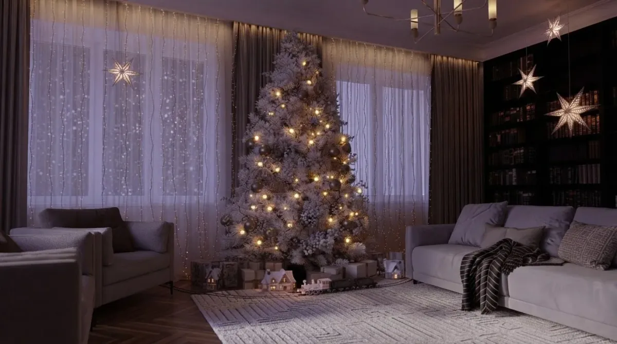 Dark home library with floor to ceiling bookshelves, paper stars hung in the window and from the ceiling, a flocked white Christmas tree with warm lights and a grey velvet sofa with a knitted throw