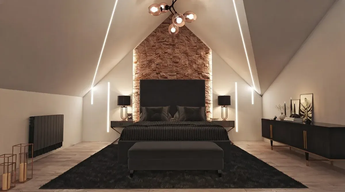 Barndominium bedroom under a steeply pitched ceiling with a stone accent wall behind a dark upholstered bed, concealed LED strips following the roof slope and a dark rug