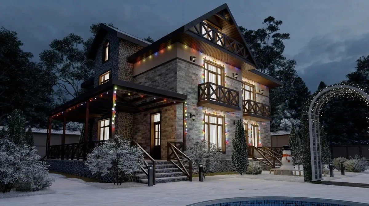 Stone and timber chalet at night with multicolour bulb lights along the eaves and balcony rails, wreaths on the windows, a lit garden arch and snow on the steps