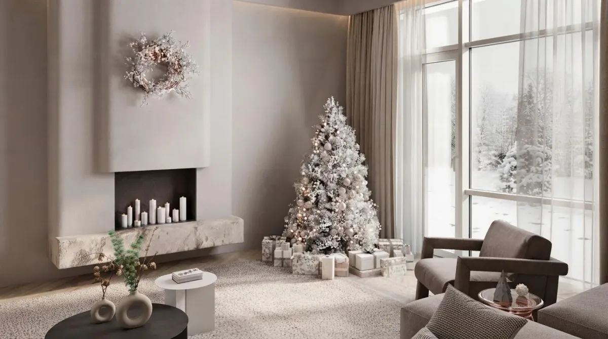 White minimal living room with a flocked Christmas tree standing between a floating stone hearth with candles and a floor to ceiling window onto snowy pines, its top a foot below the ceiling, with a grey armchair to the right